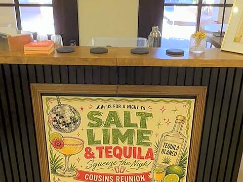 A client's custom framed banner displayed at The Salt Rim bar